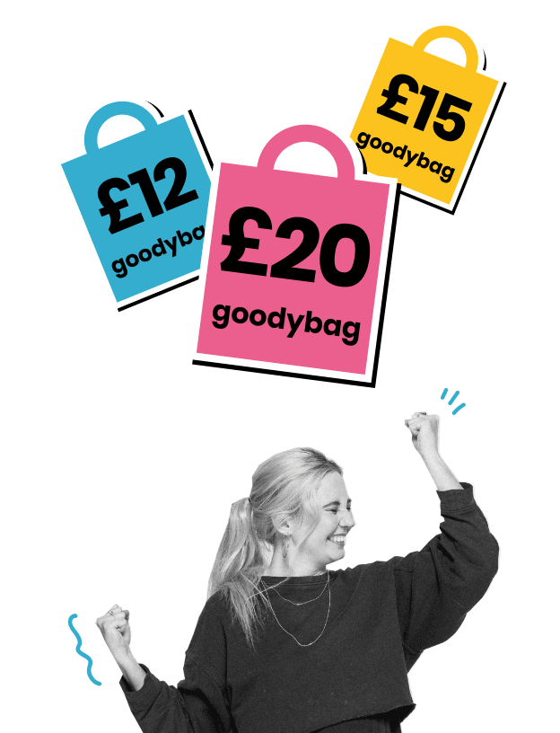 a woman looks happy while surrounded by goodybag deals of different prices